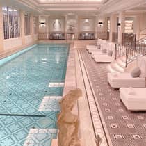 Paris Hotel indoor swimming pool with white lounge chairs on pool deck