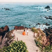 A couple enjoying scenic ocean views and dancing at Four Seasons Resort Punta Mita
