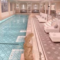Paris Hotel indoor swimming pool with white lounge chairs on pool deck
