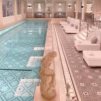 Paris Hotel indoor swimming pool with white lounge chairs on pool deck