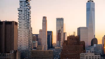 Skyscrapers in front of a sunrise.