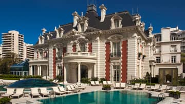 Exterior view of Four Seasons Buenos Aires hotel in historic white mansion with swimming pool