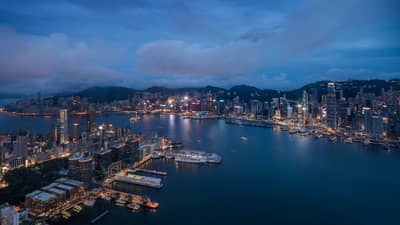 Aerial view of Hong Kong waterfront, city buildings and lights at night