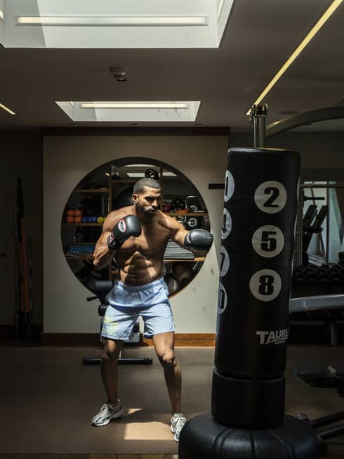 A man practicing boxing in a dark room