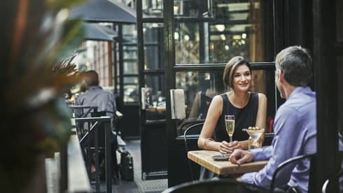 Couple dine on urban restaurant patio