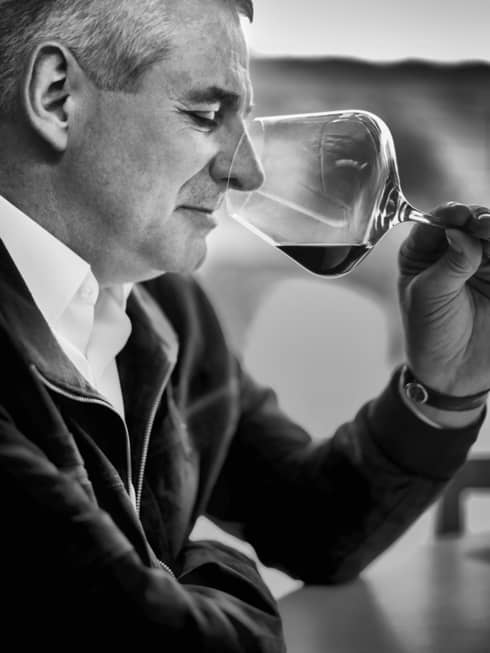 Black-and-white portrait photo of Restaurant Director Eric Beaumard with wine glass