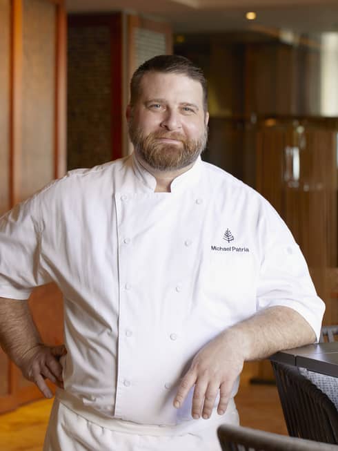 Portrait of male chef in white coat with Four Seasons logo