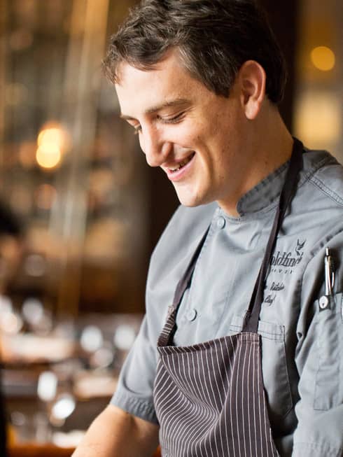 Portrait photo of Chef Joe Ritchie smiling, in apron