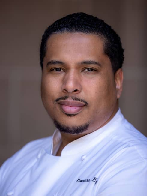 A chef in a white chefs coat.