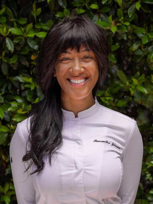 A chef in a white chefs coat.