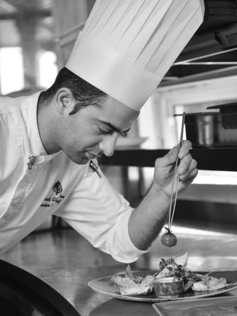 Chef from Four Seasons Hotel Doha puts final touches on a dish before sending it out
