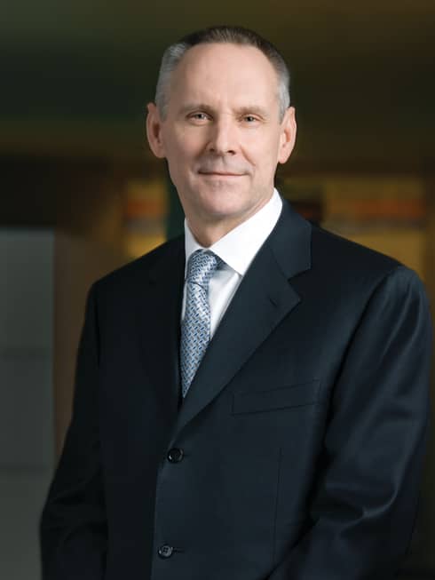 Portrait photo of Executive Vice President, Chief Financial Officer John Davison wearing suit, tie