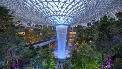 An arial view of an indoor garden with a large fountain in the center in singapore