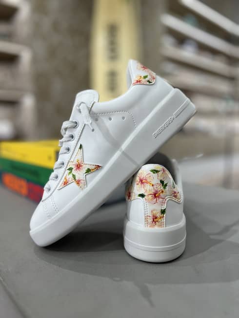 A pair of white Golden Goose sneakers with tropical flower design
