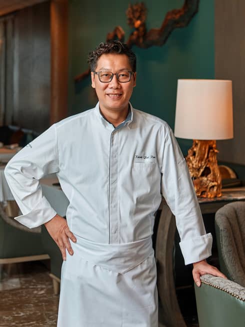 Portrait photo of Chef de Cuisine, Yu Yuan Koo Kwok Fai wearing white uniform