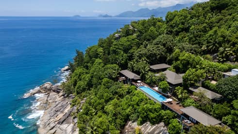 Large private villa on a lush cliff overlooking the sea in tropical location