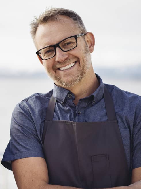 Chef Ethan Stowell smiles in his apron