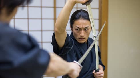 Japanese martial arts athlete training kendo in a dojo - Samaurai practicing