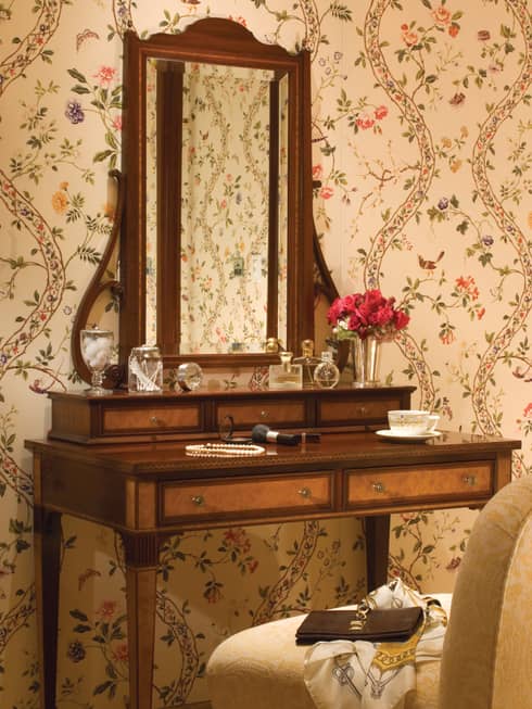 Antique-style wood vanity, mirror with perfume bottles, make-up, pearl necklace