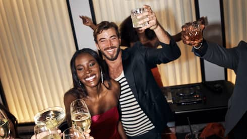 A group of people toasting at a party.