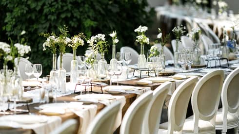 A long table set for a wedding or event outdoors