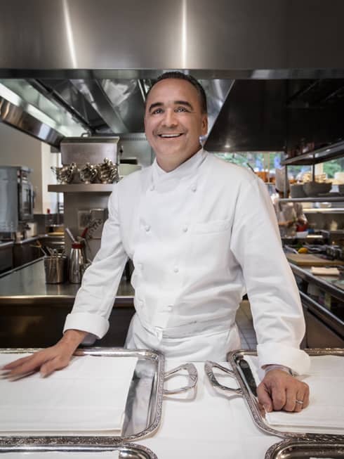 Portrait photo of Executive Chef Jean Georges wearing uniform on kitchen line