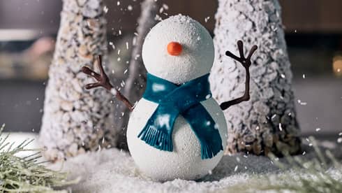 A small snowman and Christmas tree decoration