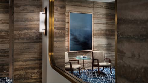 View ofwood-panelled interior room with seating area