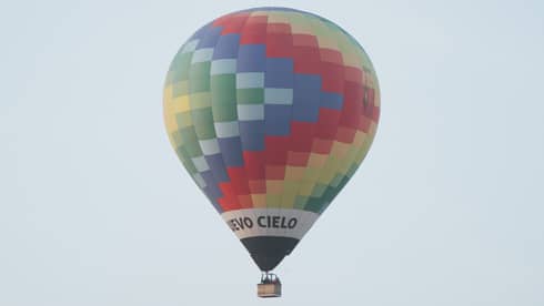 A hot air ballon floating in the sky.