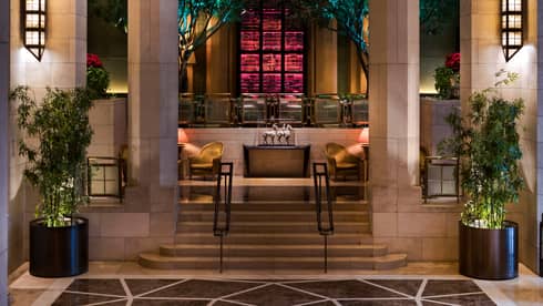 Lanterns on stone pillars, stairs leading up to The Garden bar and lounge 