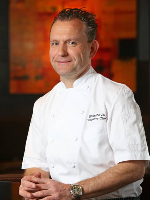 Portrait photo of Executive Chef Simon Purvis in white uniform