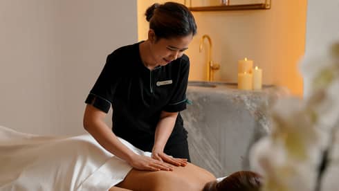 A woman receiving a massage treatment in a spa.