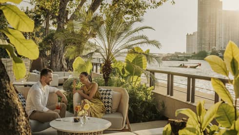 Man and woman enjoying a drink in the outdoor lounge