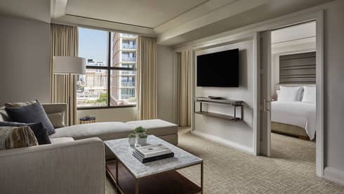 City View Executive Suite living room, window, TV on wall dividing bedroom