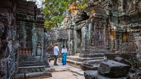 Man and woman tour Angkor Wat ruins