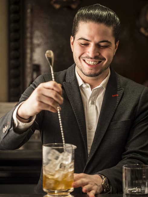 Harry Nikolaou, head bartender of Rotunda Bar, stirs a cocktail
