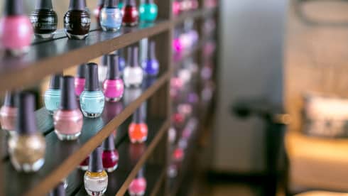 Close-up of colourful eco-friendly nail polish bottles on shelf at Driftwood Spa