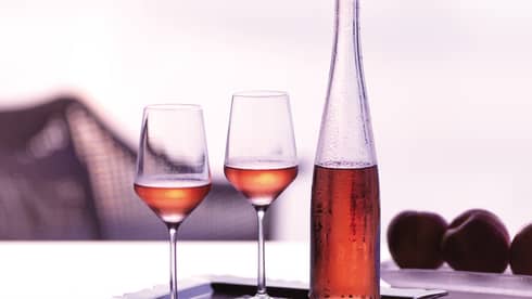 Tray with two wine glasses and glass bottle with rosee 