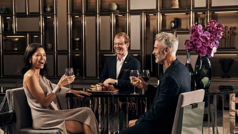 A group of people enjoying wine in a lounge.