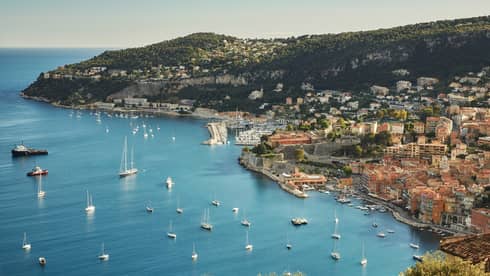 Aerial view of French Riviera waterfront, buildings along coast, yachts, boats in sea