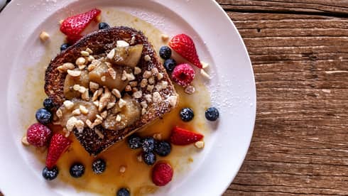 Coconut brown sugar french toast with strawberries and blueberries