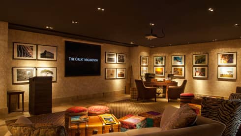 Sofas, armchairs, stacks of National Geographic magazines on table