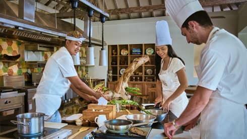 Two guests receive cooking lesson at Four Seasons hotel