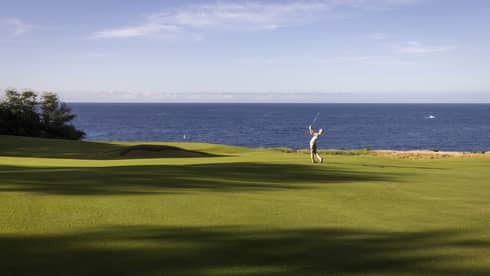 Golfer on oceanside fairway at Four Seasons Resort Lanai