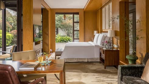 Luxury hotel guest room featuring king bed and garden views