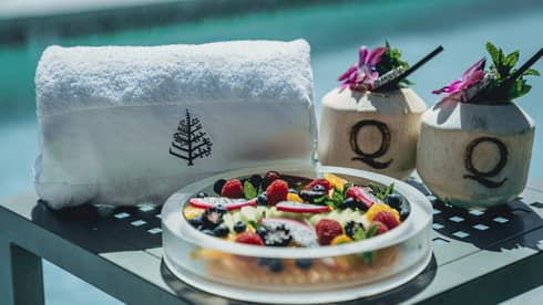 A bowl of fruit near a towel.