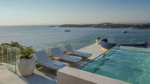 Arion Presidential Suite rooftoop with plunge pool, lounge chairs, boats on the Mediterranean in the background