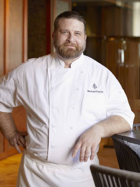 Portrait of male chef in white coat with Four Seasons logo