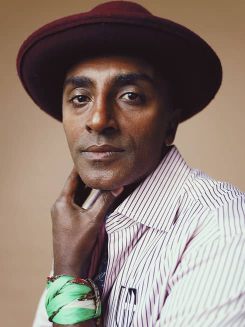 Close up of Chef Marcus Samuelsson wearing hat and stripped shirt