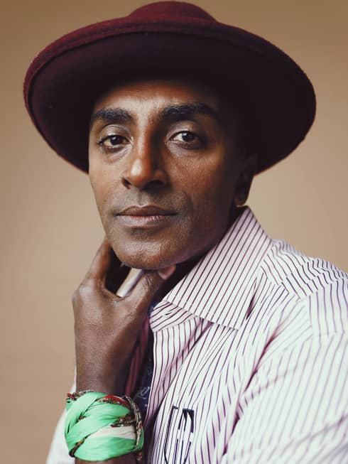 Close up of Chef Marcus Samuelsson wearing hat and stripped shirt